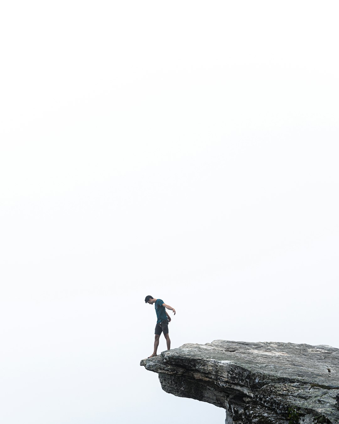 man-in-black-shirt-standing-on-rock-bklmrjb89gc